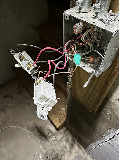 Exposed electrical box with colorful wires and complex internal components
