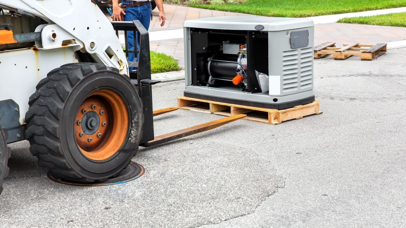Commercial generator being delivered by forklift to a property
