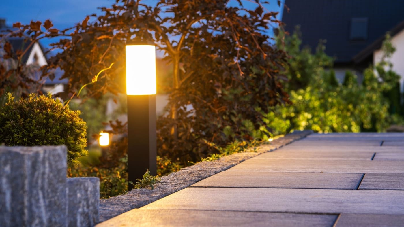 Deck and facade uplighting on a home at evening