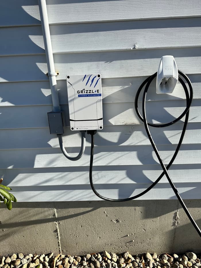 A Grizzl-E Level 2 EV charger mounted on the garage wall and fed by its own dedicated circuit.
