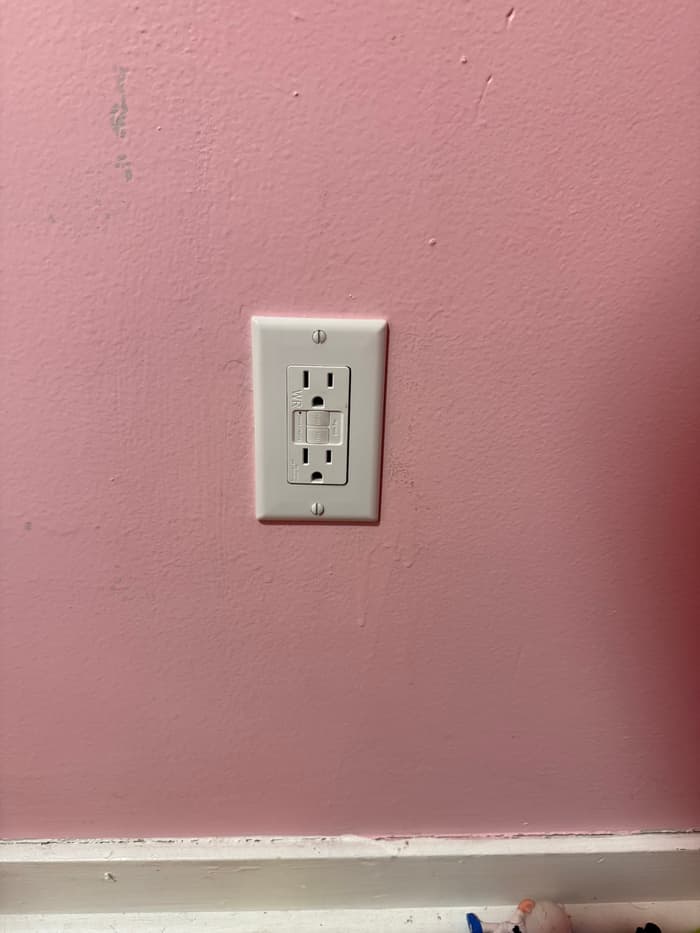 A tamper-resistant GFCI receptacle installed to bring an outlet up to current code.