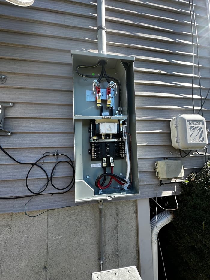 An exterior disconnect and subpanel wired out with new breakers, feeders, and grounding.