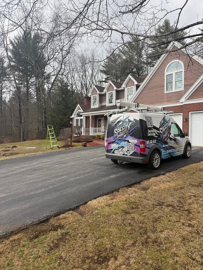 The Speedy Sparky van parked at a New Hampshire home for a scheduled service call.