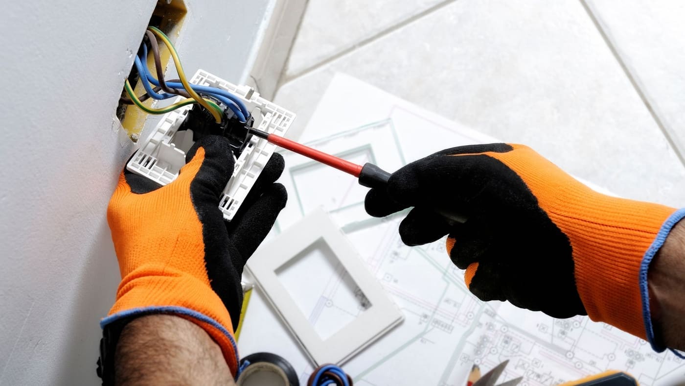 Electrician installing a standby generator outside a residential home