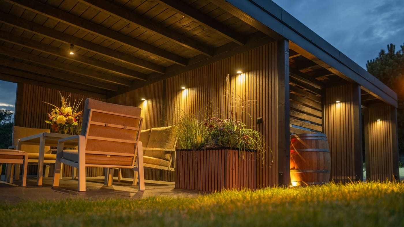 Covered outdoor pavilion with ceiling and deck lighting at dusk