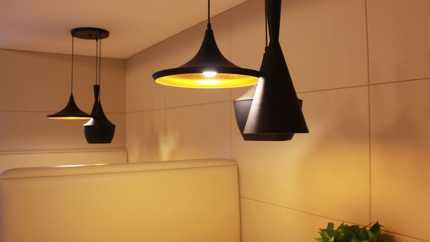 Recessed ceiling light fixtures being installed in a residential ceiling
